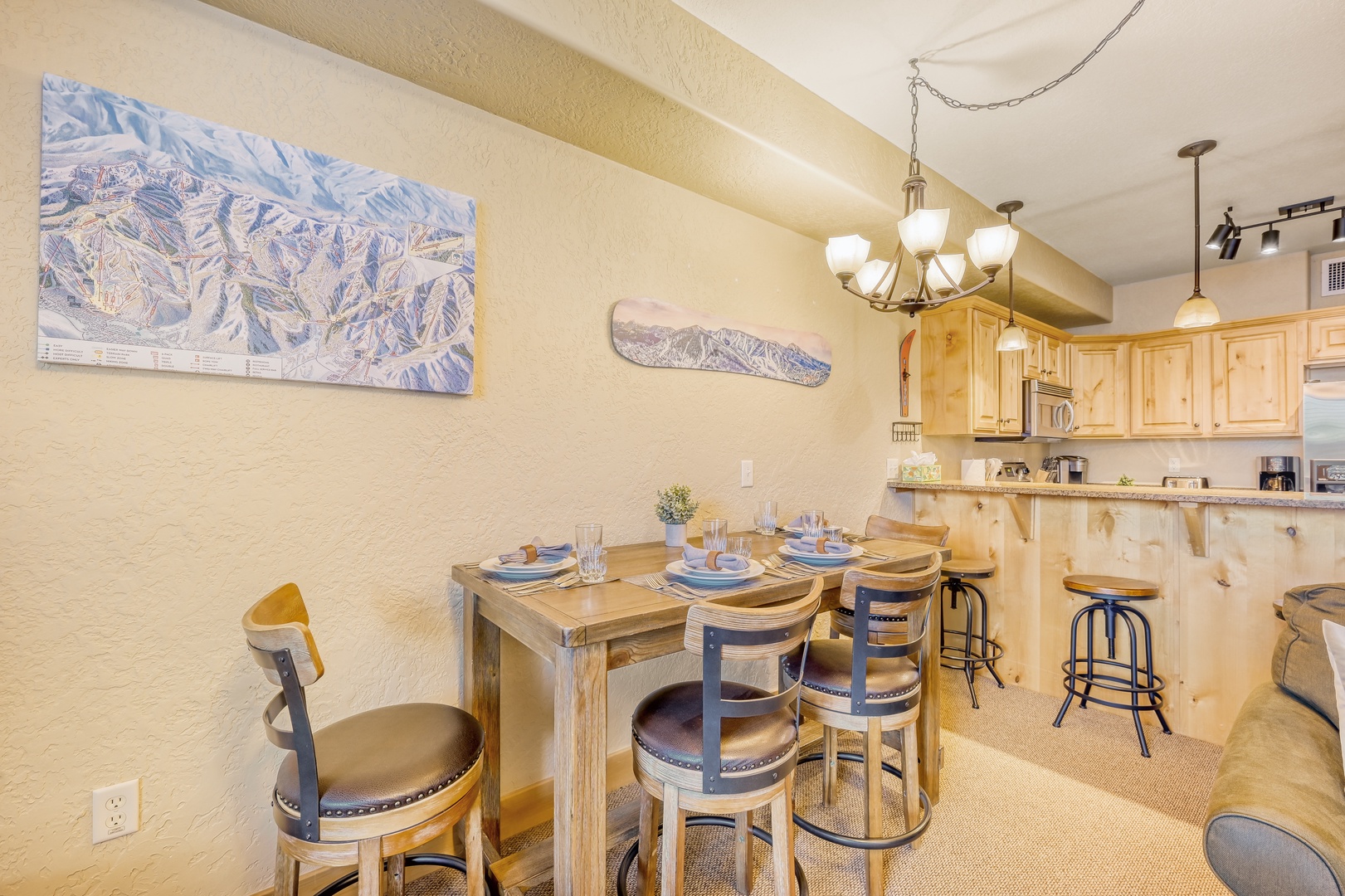 Gather around this cozy dining space where mountain charm meets modern comfort. The warm wood table and rustic décor create the perfect spot.