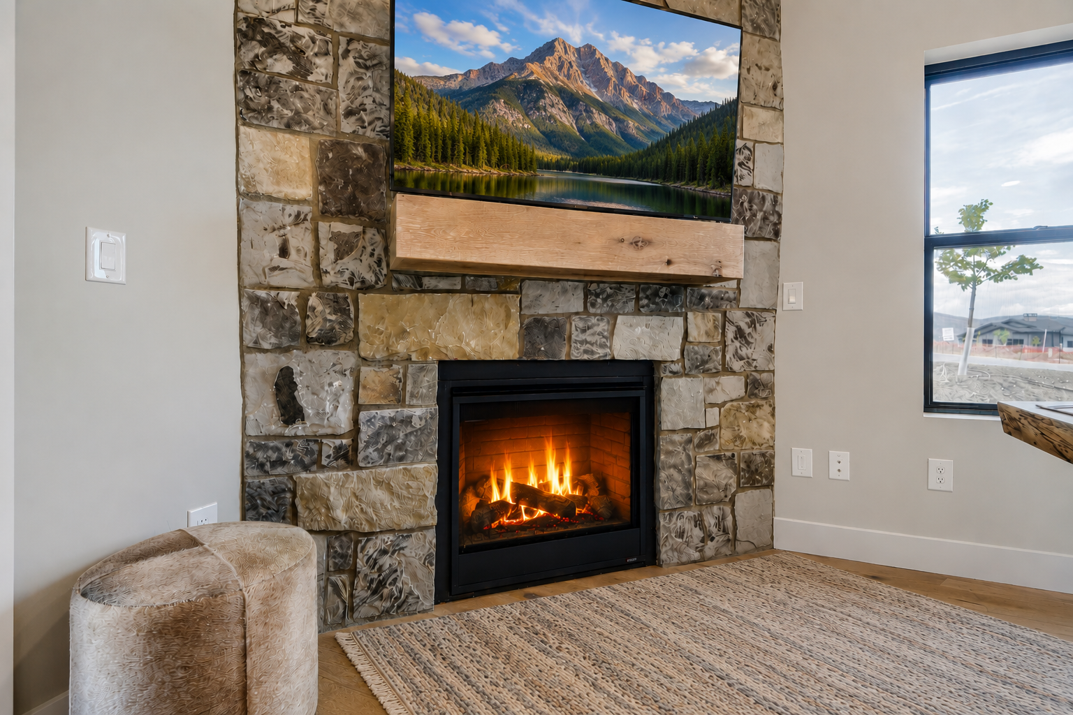 Gather by the glowing fireplace under mountain vistas, where rustic stone and modern comfort create your perfect retreat setting.
