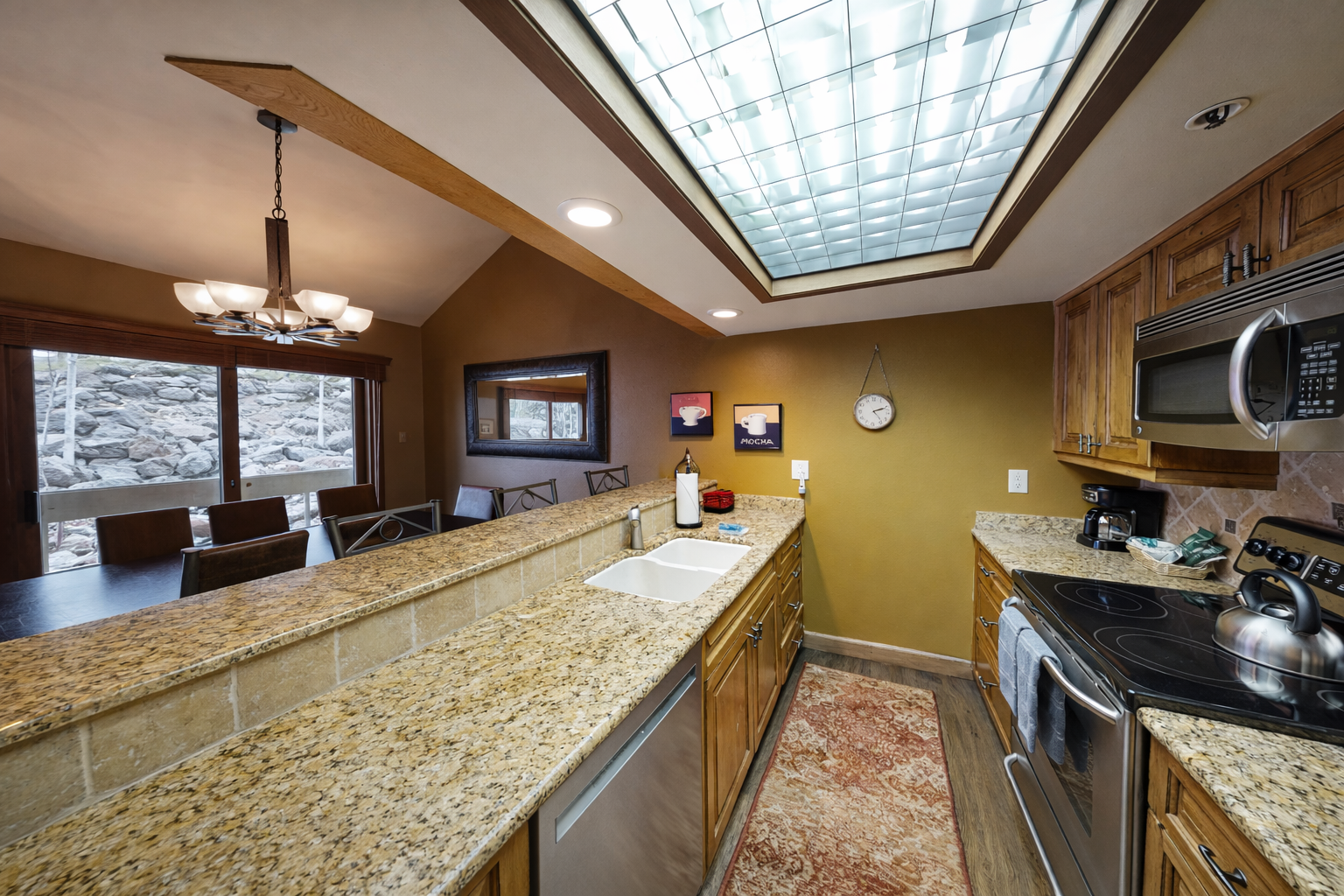 Your spacious kitchen features granite counters, full appliances, and a skylight that bathes your culinary creations in natural light.