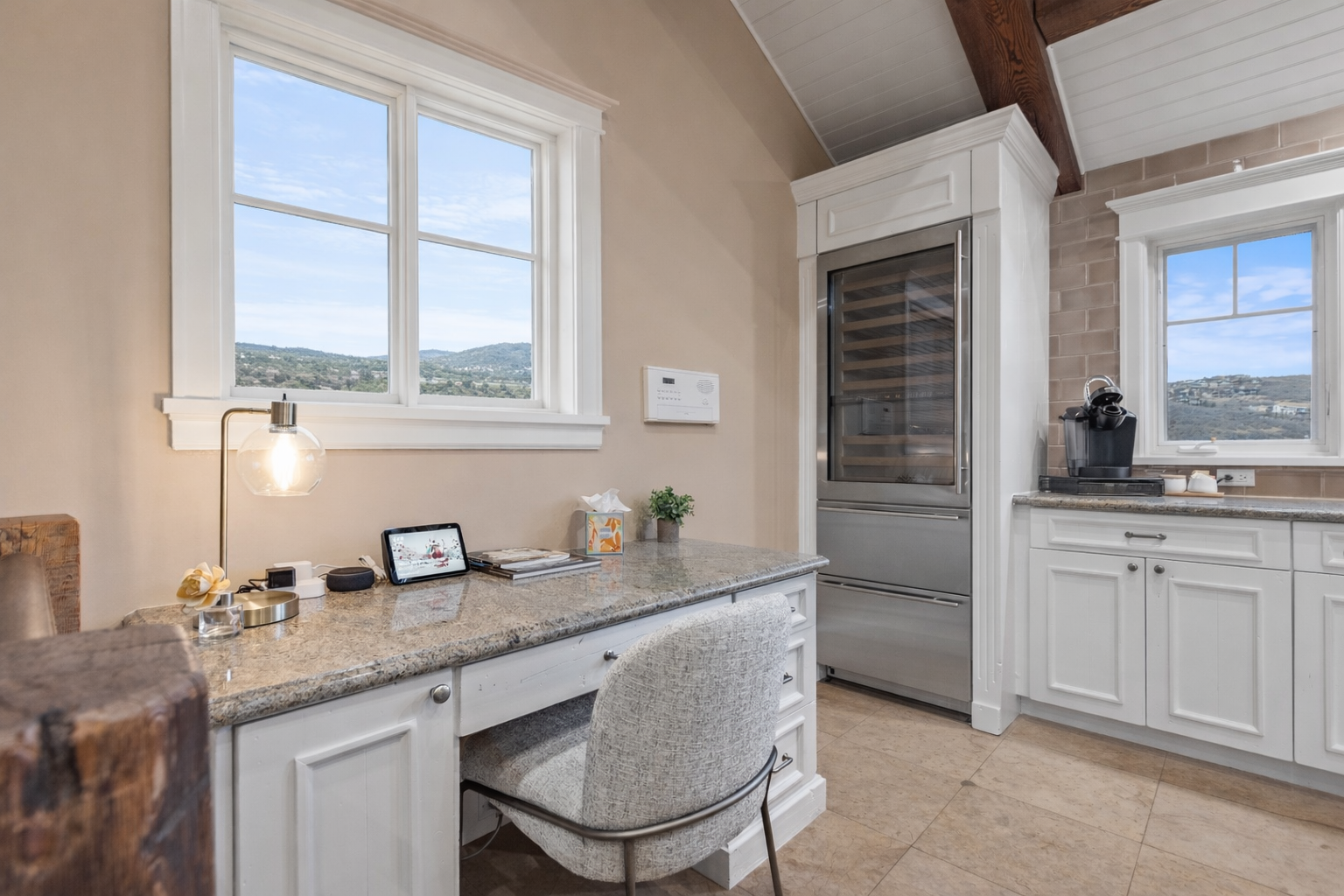 Your kitchen workspace combines style with function—granite counters, premium appliances, and inspiring mountain views make cooking and remote work a pleasure.