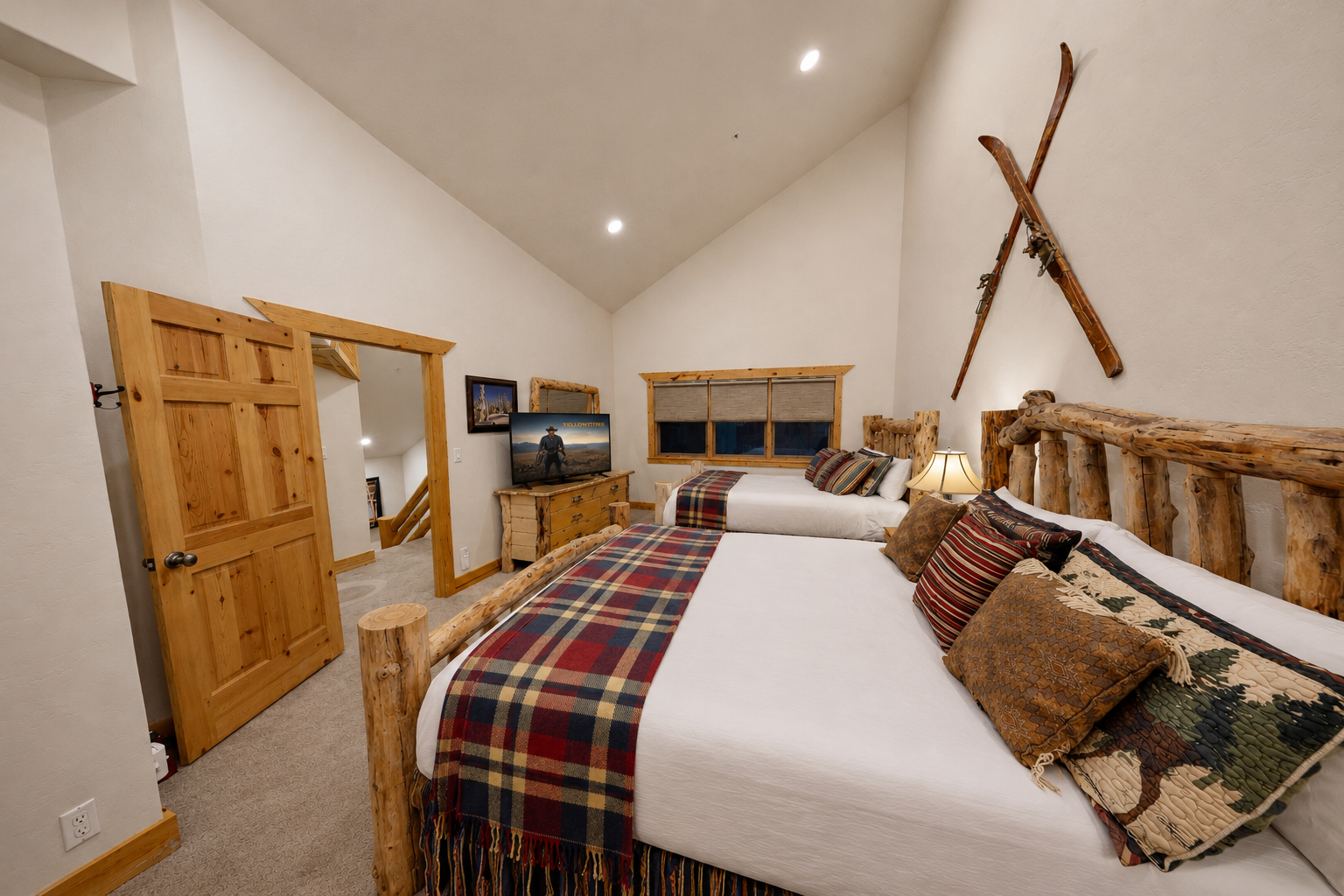 Settle into your cozy mountain retreat with rustic log-frame beds dressed in plaid throws and a charming ski-inspired décor that invites relaxation after a day of adventure.