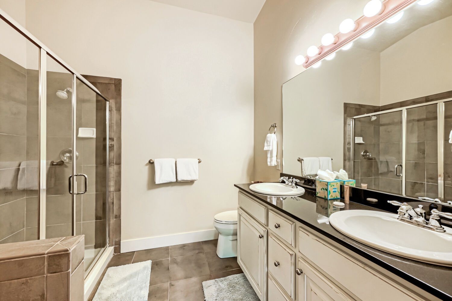 Your private bathroom awaits with dual sinks, generous counter space, and a spacious walk-in shower—everything you need to refresh and recharge after a day of adventure.