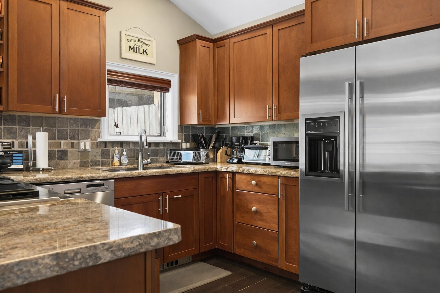 Your gourmet kitchen features granite counters, stainless appliances, and warm pendant lighting for memorable meal prep moments.