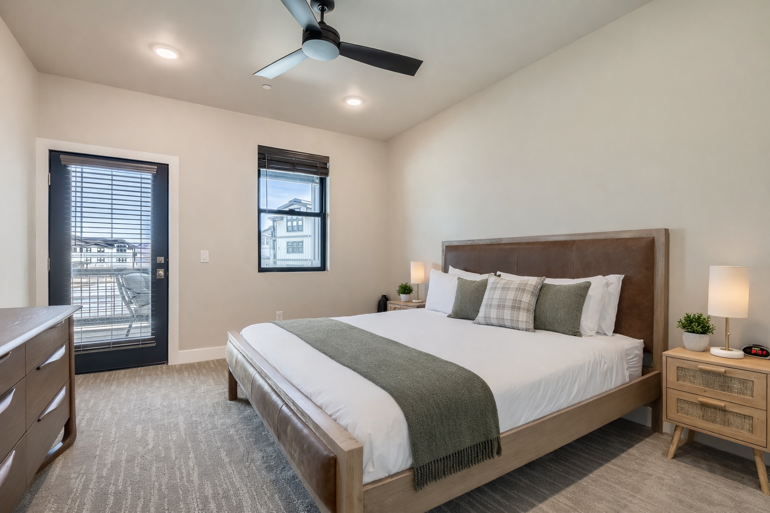 Sink into your plush king bed with cozy linens while the ceiling fan keeps you comfortable in this serene, modern retreat.