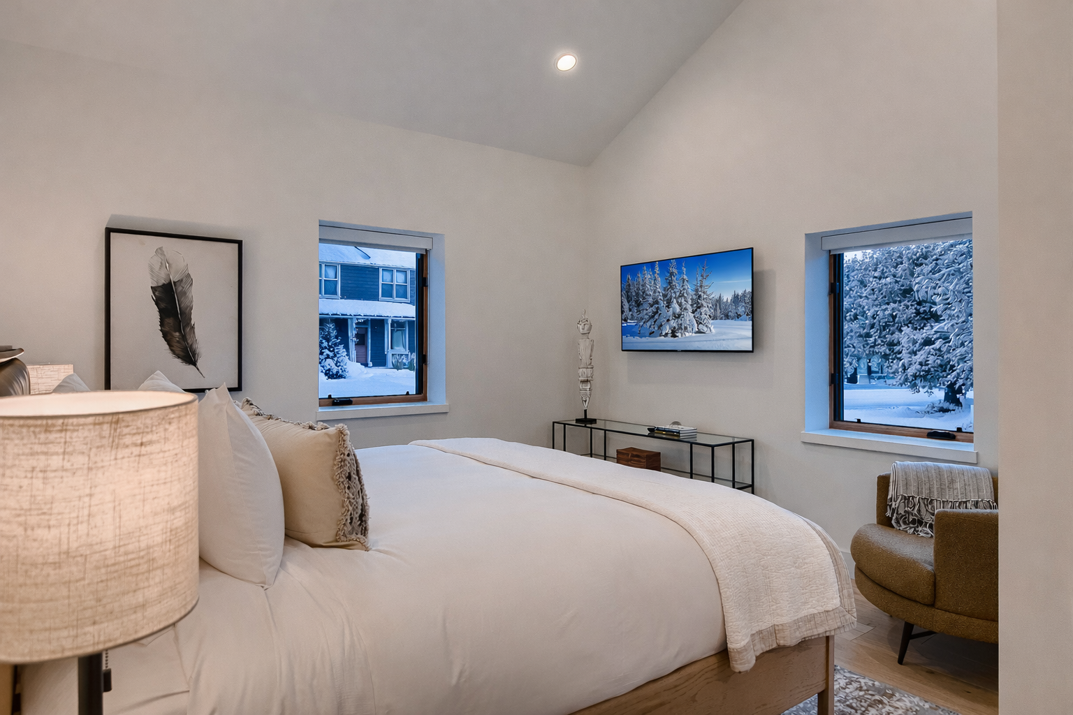 Retreat to the elegant king guest room featuring a plush king-size bed, a smart TV, and ample natural light.