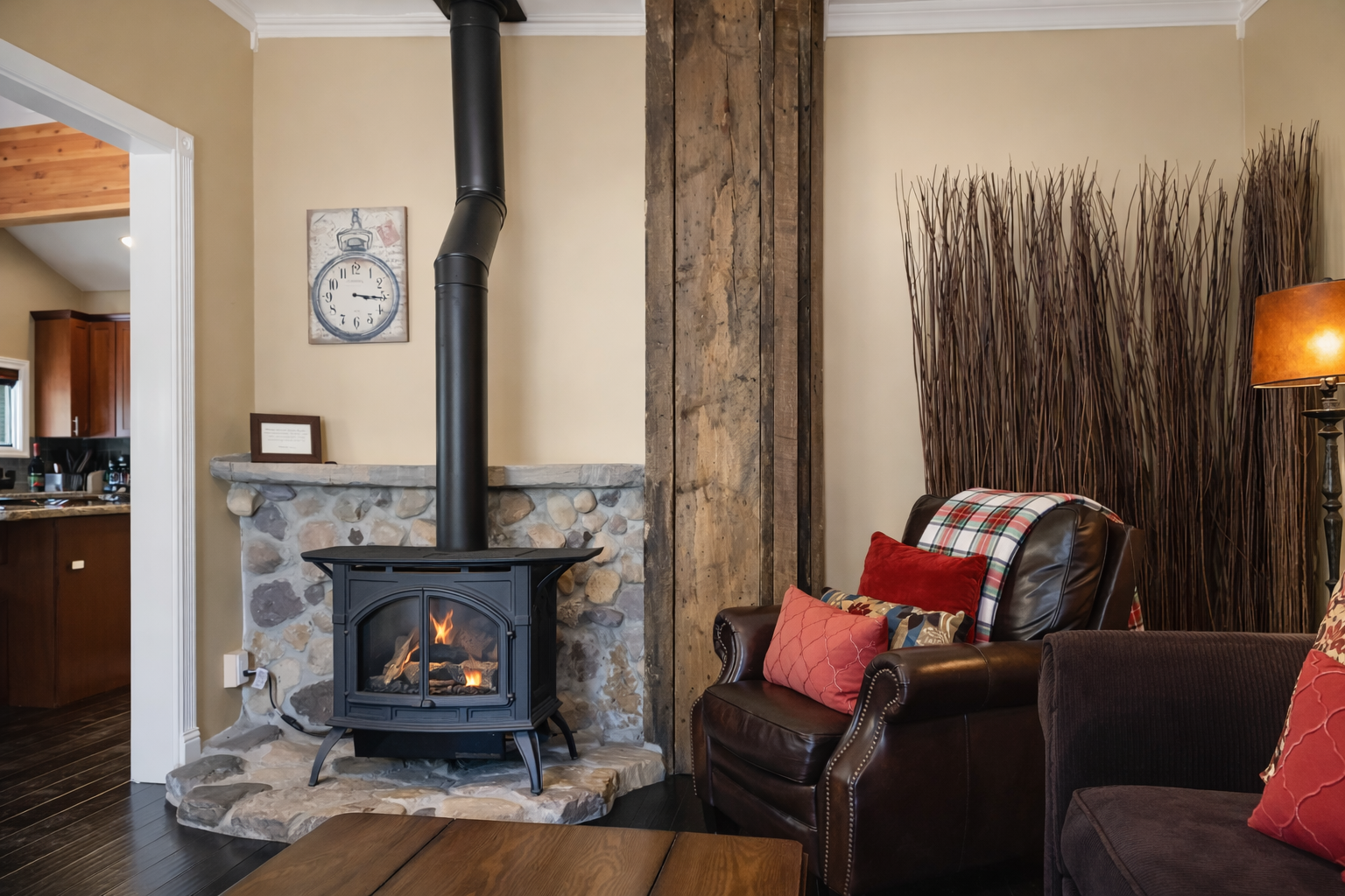 Curl up in your cozy leather chair beside the crackling wood-burning stove, where rustic stone and warm accents create the perfect retreat.