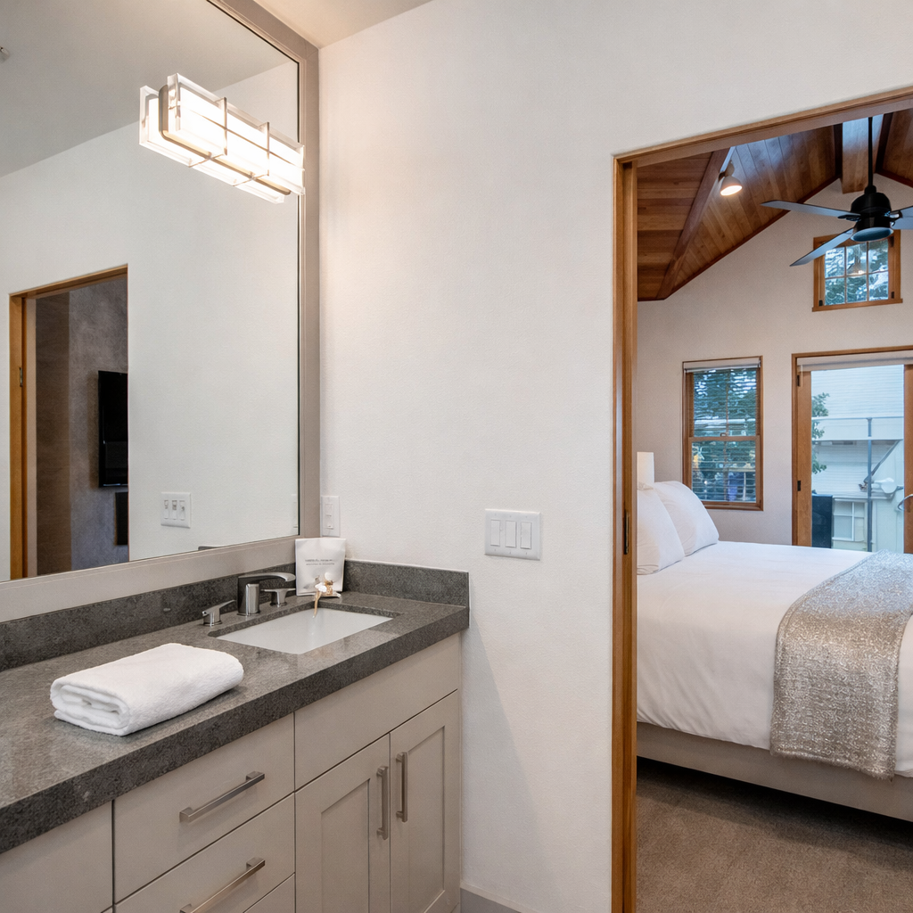 Your bedroom opens to a stylish ensuite with granite counters, fluffy towels, and modern fixtures.