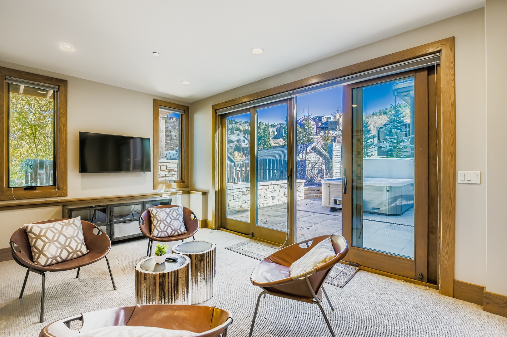 Relax in this stylish living space with modern seating, a flat-screen TV, and sliding glass doors opening to your private patio with a hot tub awaiting.