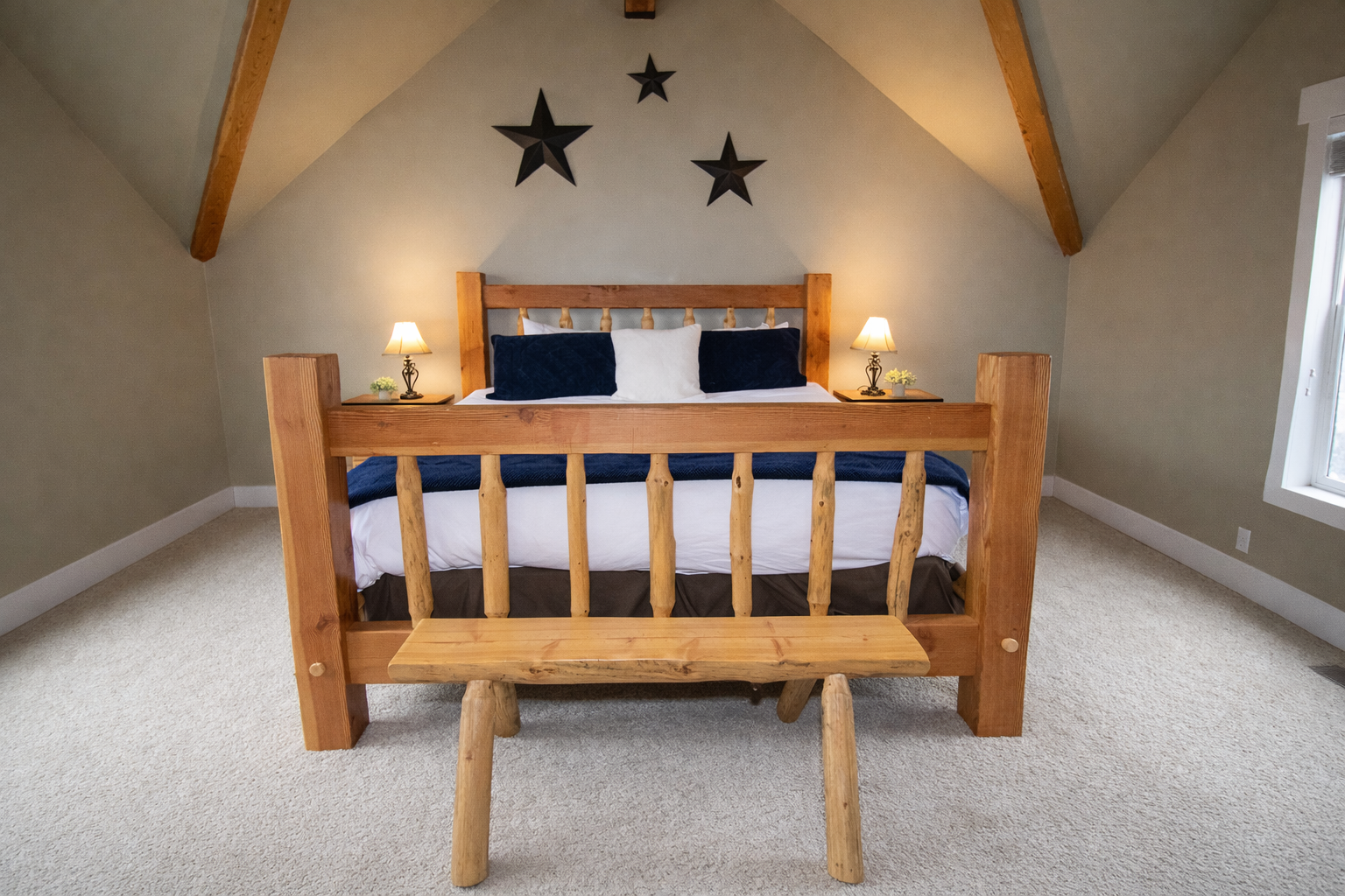 Relax in this spacious master suite on its own private floor. Features include a king-sized log bed, vaulted ceilings, and a large walk-in closet for the ultimate mountain retreat.
