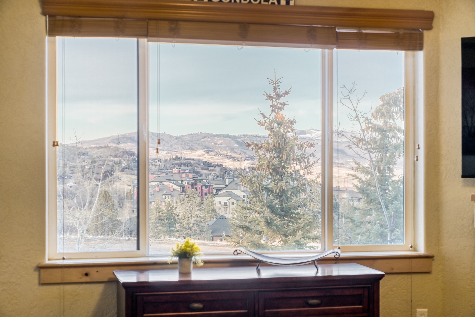 Wake up to stunning valley views from your cozy workspace, where morning light streams through wide windows.
