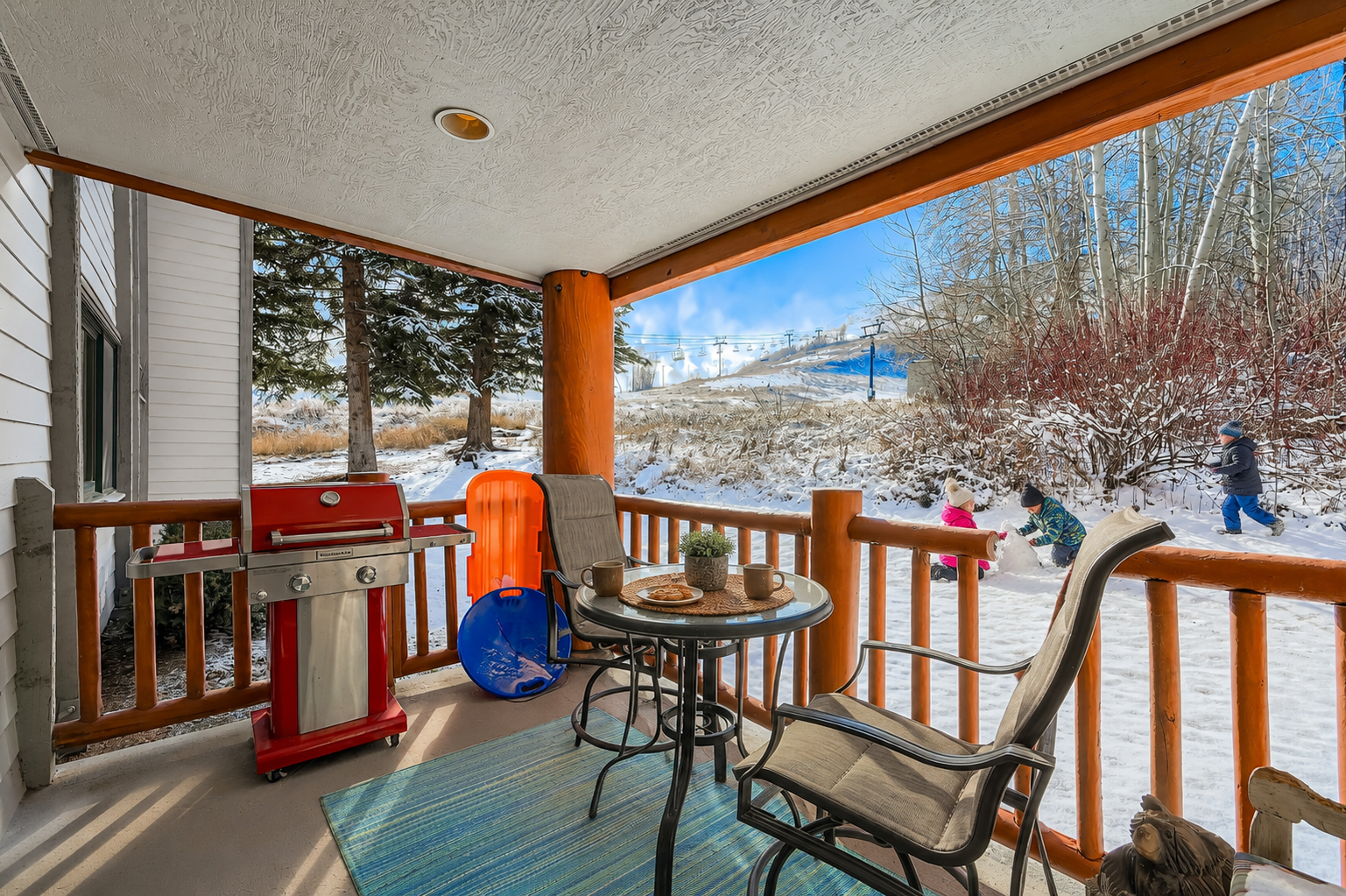 Your private covered balcony offers a cozy spot to enjoy morning coffee while watching snow play unfold just steps away, with mountain views and a BBQ ready for your alpine dining.