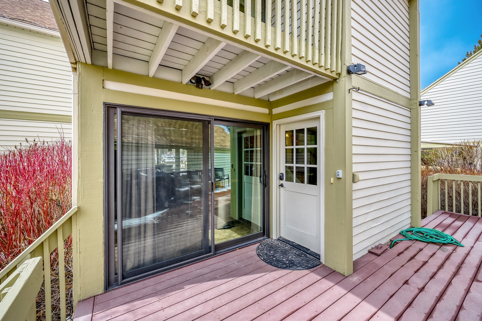 Step onto your private deck through sliding doors and enjoy outdoor relaxation under the upper balcony's shade.