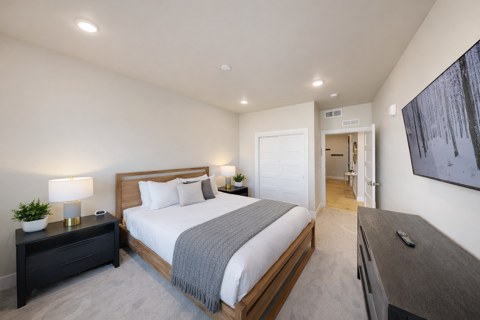 Sink into crisp linens and soft pillows in your serene bedroom sanctuary, where warm lighting and modern comfort create the perfect retreat.