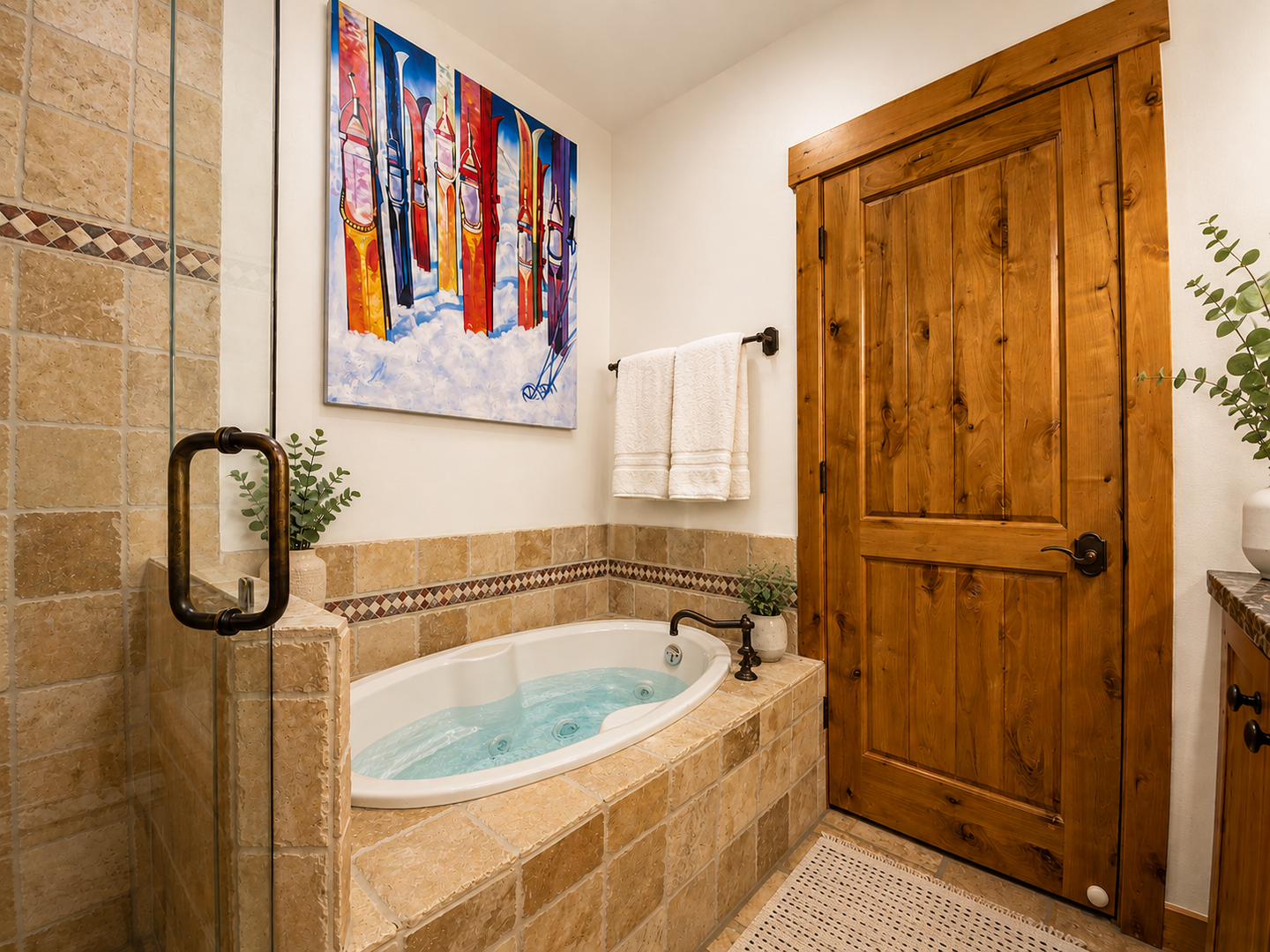 Soak away the day in your private jetted tub, surrounded by warm travertine, soft towels, and vibrant local art that brings mountain charm right into your retreat.