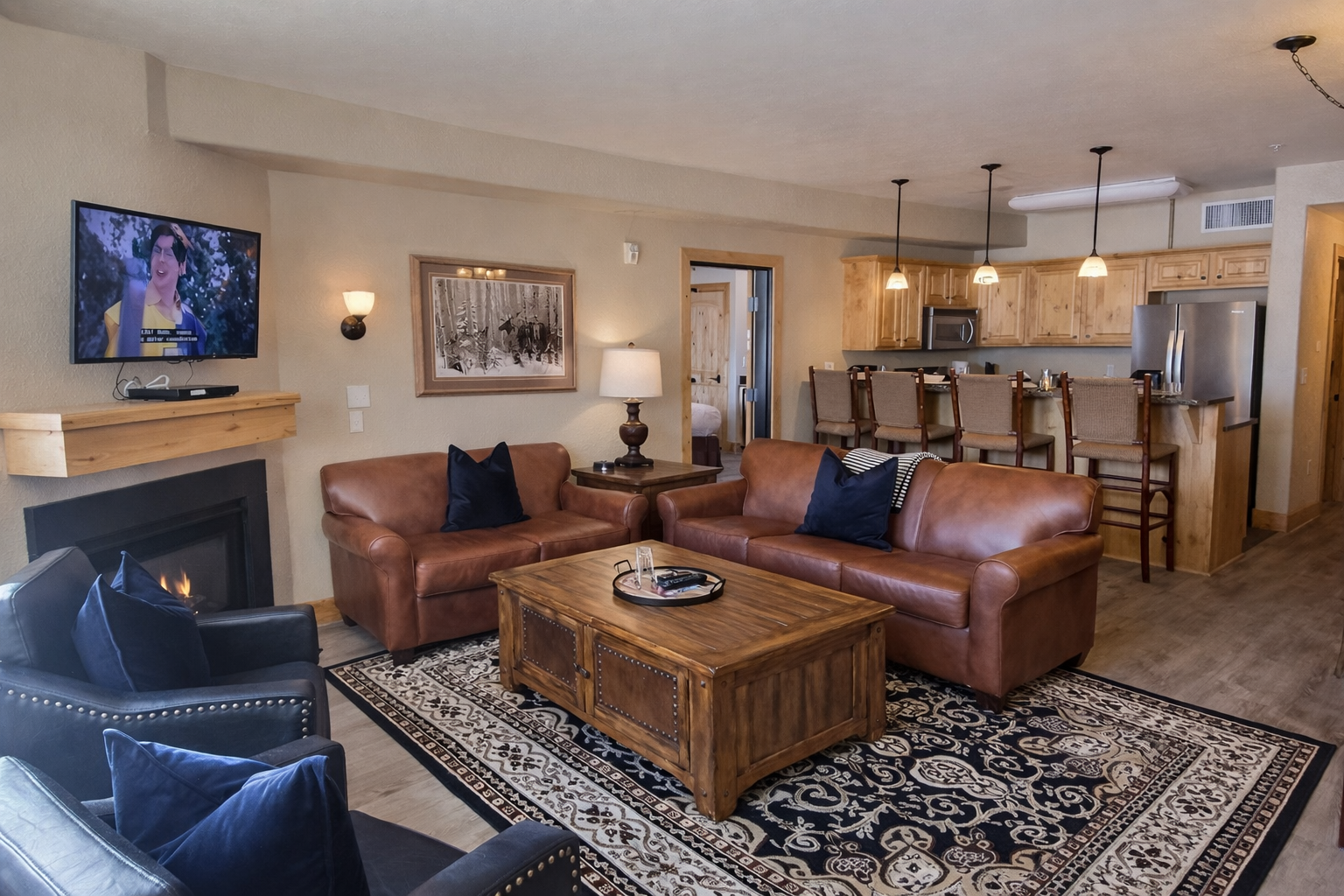 Unwind in this sun-drenched mountain retreat featuring a cozy fireplace, plush leather seating, and large windows. Perfect for relaxing after a day of adventure with stunning alpine views.