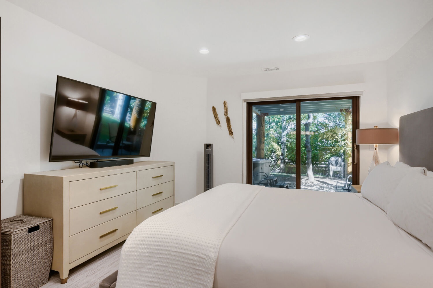 Unwind in your private retreat with a plush bed and glass doors opening to a peaceful outdoor patio. Natural light streams in, inviting restful mornings and serene evenings.