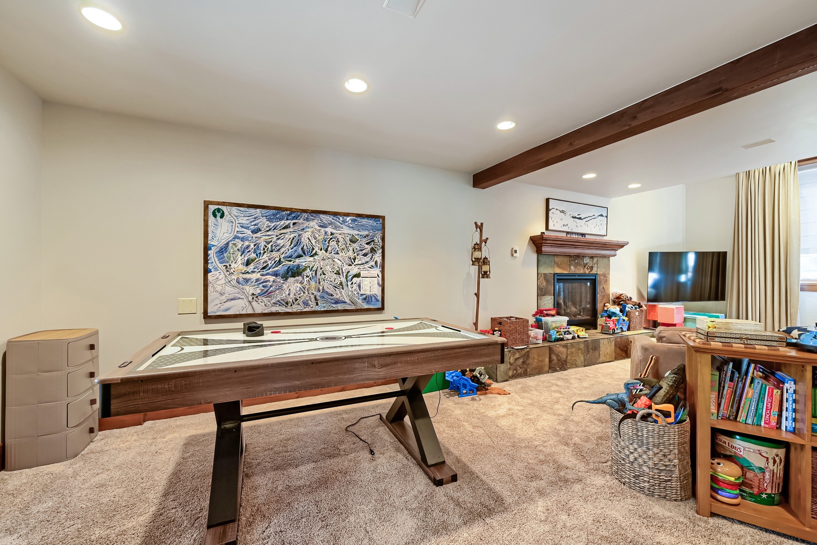 Your private game room invites friendly competition with a sleek air hockey table, cozy fireplace, and entertainment center—perfect for family fun after a day on the slopes.