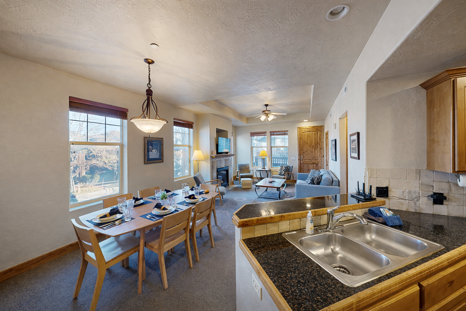 Your open-concept retreat combines kitchen, dining, and living spaces, where morning coffee flows into shared meals and cozy evenings by the fireplace.
