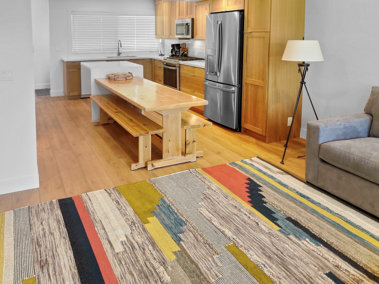 Your open-concept kitchen is ready for meal prep with modern stainless steel appliances, warm wood cabinetry, and plenty of counter space to spread out and cook comfortably.