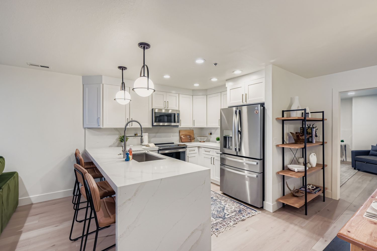 Your modern kitchen features stainless steel appliances, quartz countertops, and a spacious island where you can enjoy meals or prep your favorite dishes in style.
