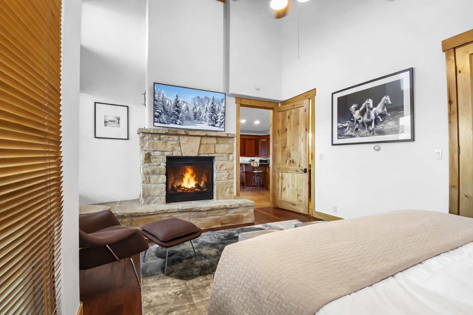 Unwind in your cozy bedroom where a crackling stone fireplace creates the perfect ambiance for relaxing evenings after mountain adventures.