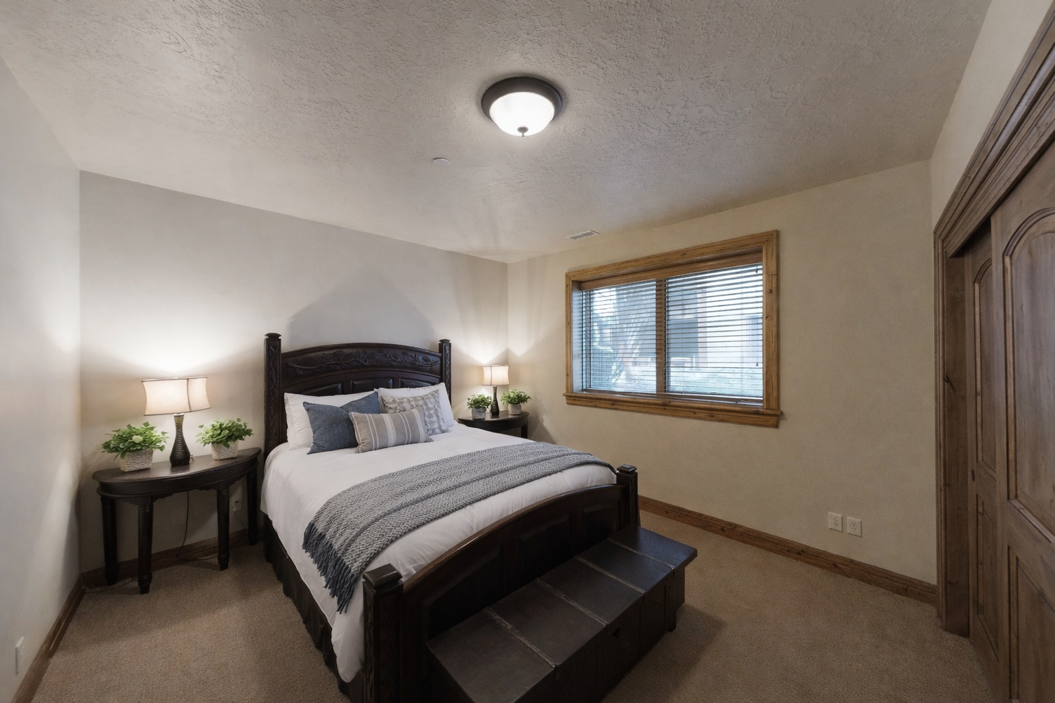 Sink into this cozy bedroom's plush bed after your day of adventure, with soft linens and warm lighting creating the perfect retreat.