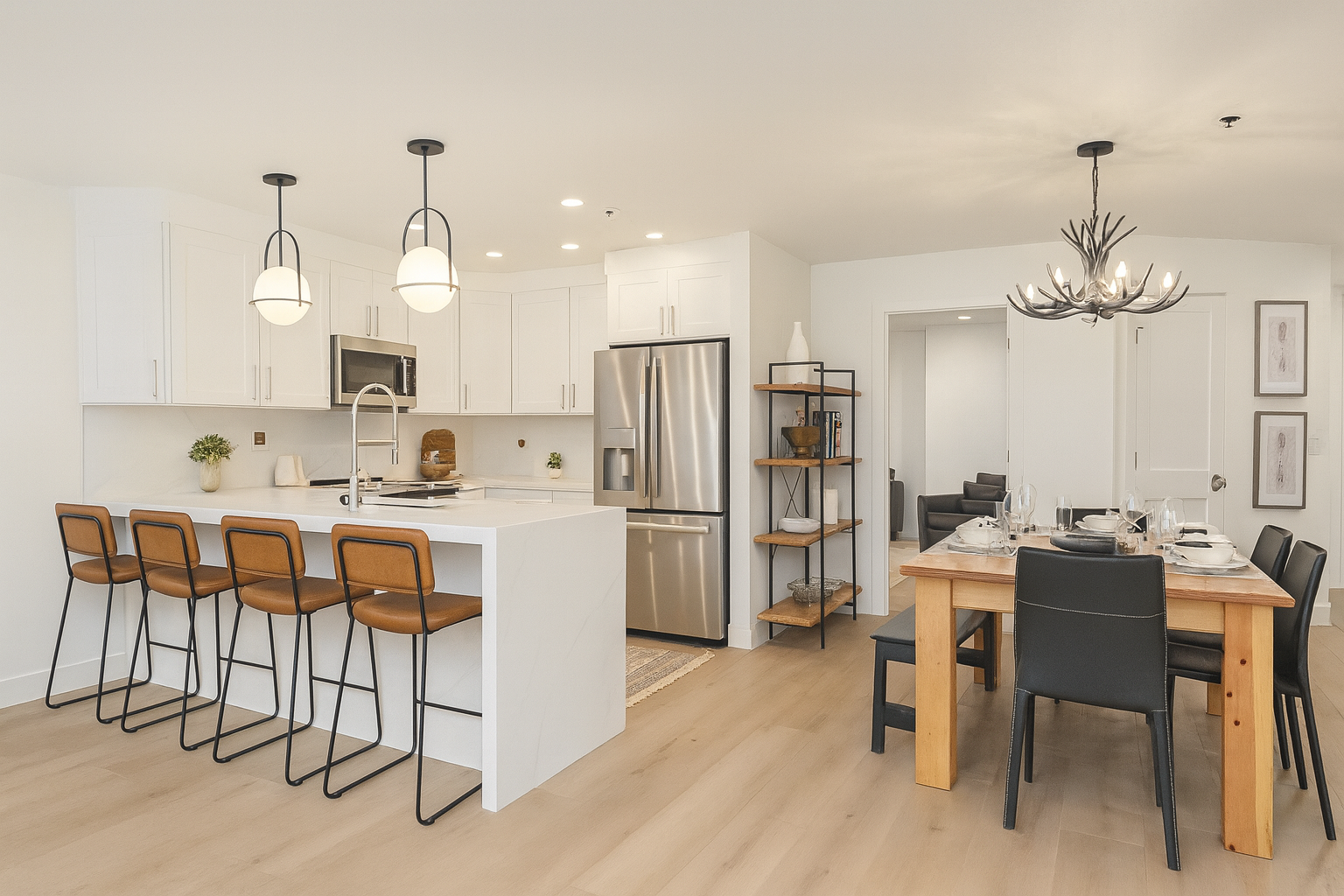 Your modern open-concept kitchen and dining area features sleek white cabinetry, stainless steel appliances, and a stylish breakfast bar with leather stools for casual meals.