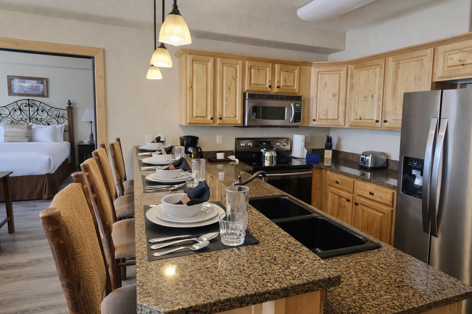 Whip up gourmet meals in this fully equipped kitchen featuring sleek granite countertops, modern stainless steel appliances, and elegant pendant lighting. The open layout makes hosting a breeze!