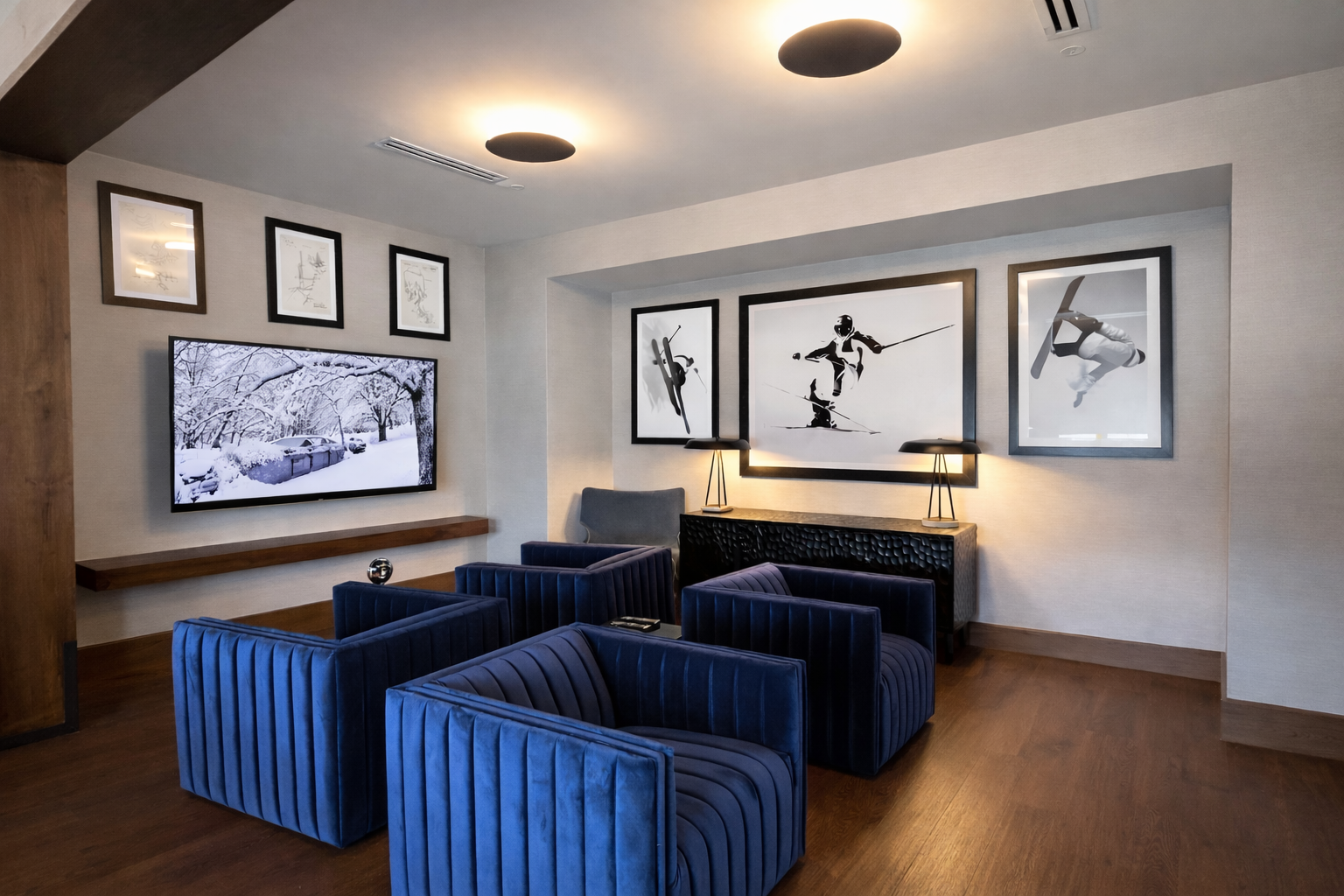 Sink into these plush blue velvet chairs while watching your favorite shows on the large TV in this stylish lounge area.