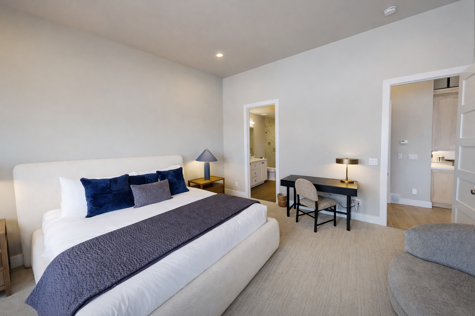 Unwind in your serene bedroom sanctuary featuring crisp linens, a dedicated workspace, and private ensuite for the perfect blend of rest and productivity.