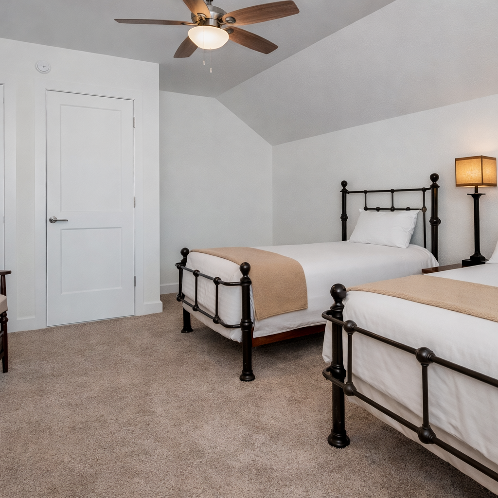 Rest peacefully in your charming twin bedroom with classic iron beds, cozy linens, and gentle ceiling fan keeping you comfortable throughout the night.