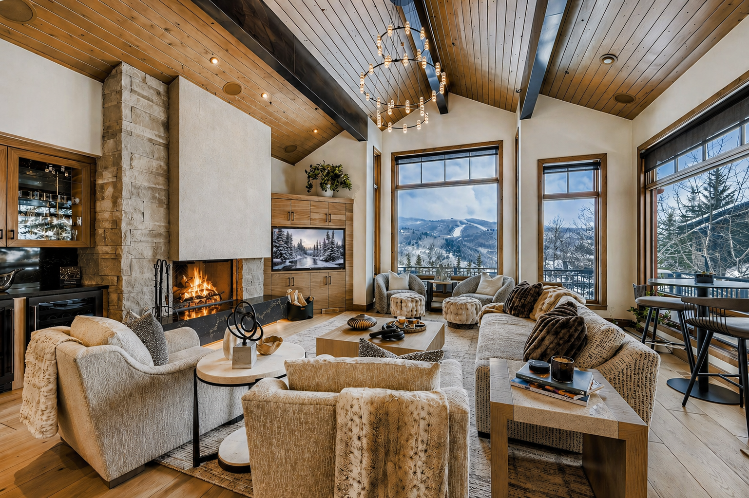 Sink into plush sofas by your crackling fireplace while breathtaking mountain views fill floor-to-ceiling windows.