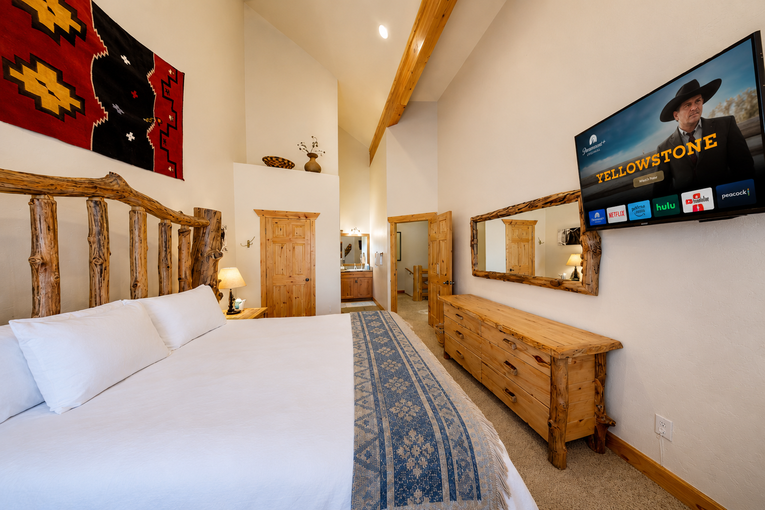 Unwind in your rustic-chic bedroom featuring handcrafted log furnishings, vaulted ceilings, streaming entertainment, and southwestern-inspired décor that brings mountain charm to life.