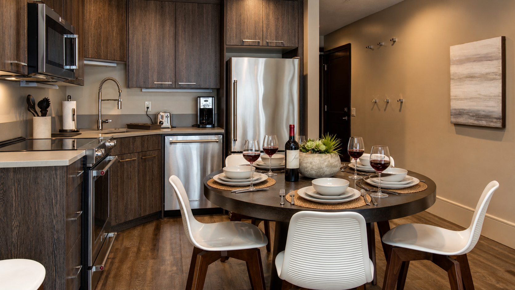 Enjoy our fully equipped kitchen with modern stainless steel appliances and a comfortable round dining table. This bright, efficient space is perfect for meals during your stay.