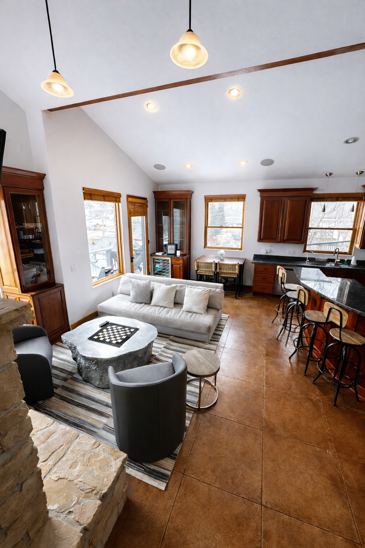 Relax in your open-concept living space where rich wood cabinetry meets modern comfort—perfect for cooking together and unwinding.