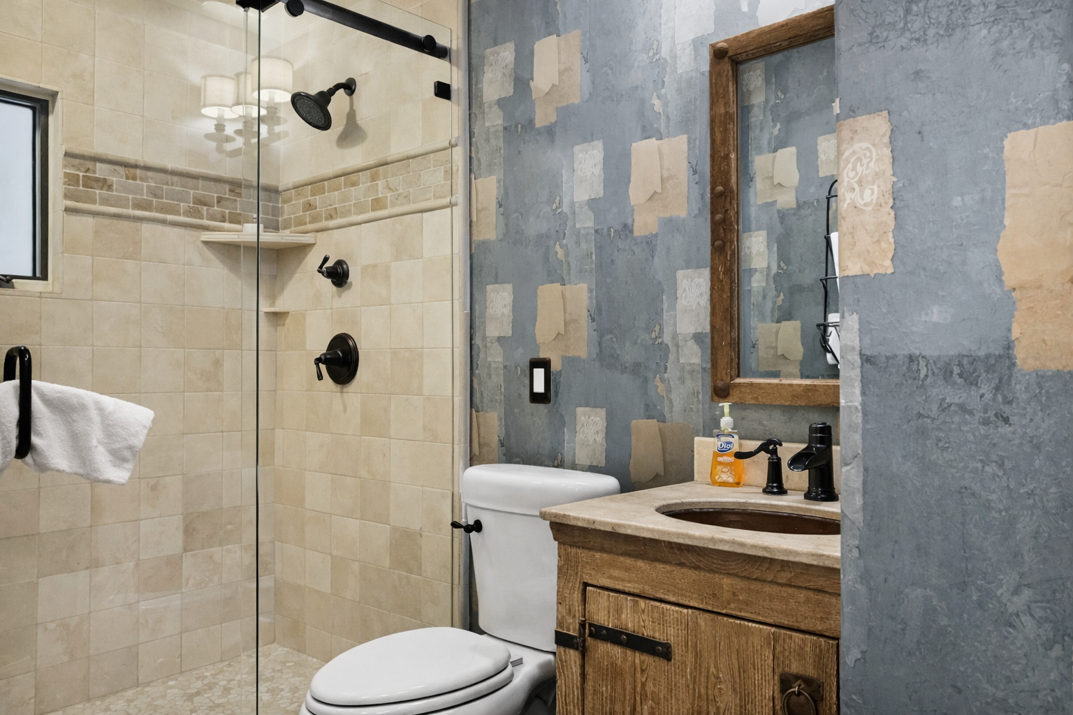 Your private bathroom features a glass-enclosed shower, modern fixtures, and rustic wood vanity for your comfort.