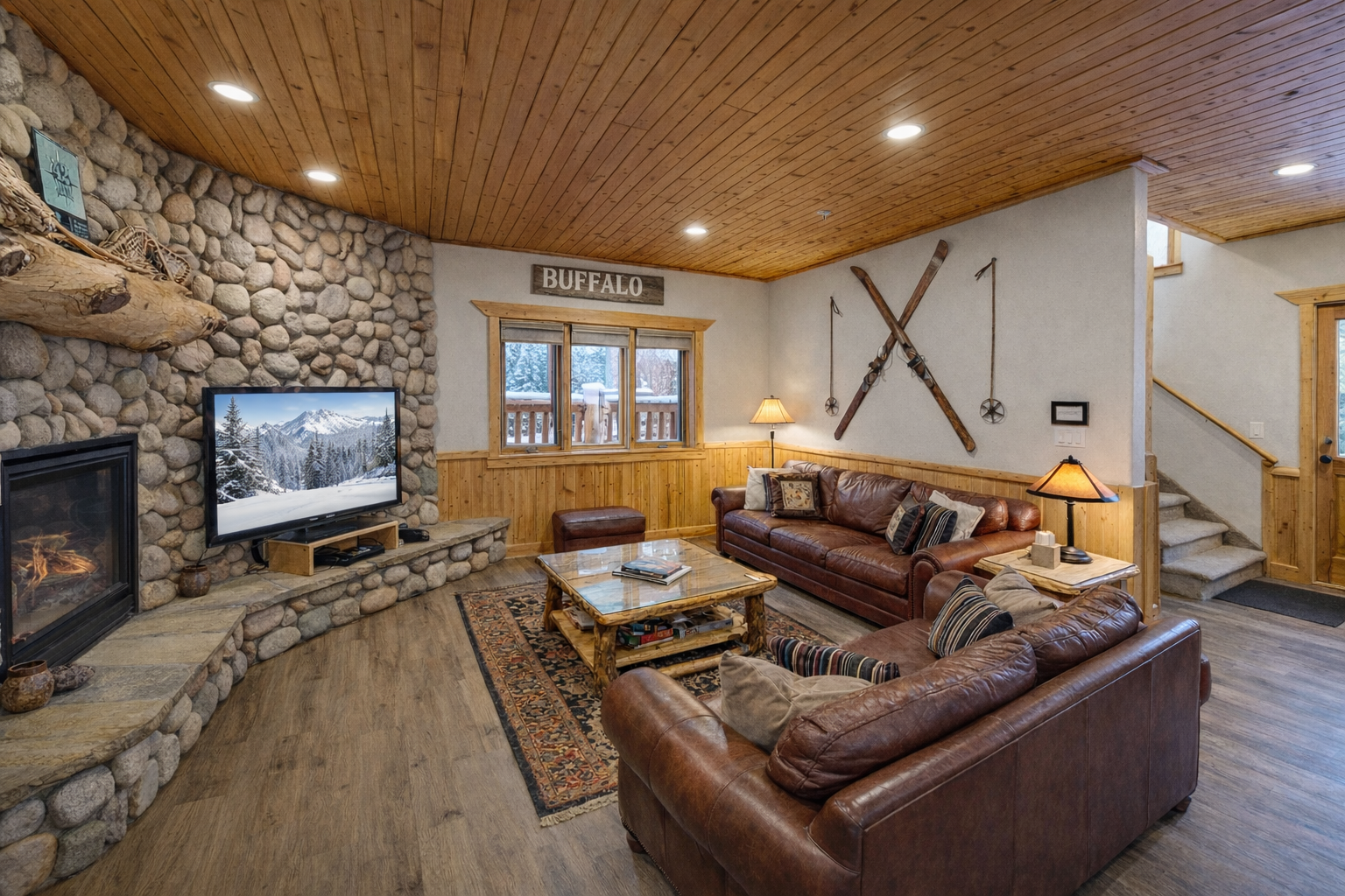 Sink into rich leather sofas by the stone fireplace and enjoy mountain views on the TV after your ski adventures.