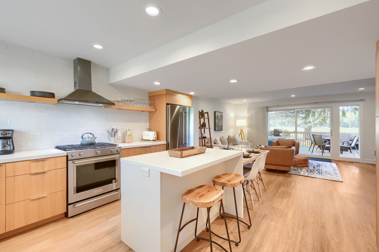 Large Open Chefs kitchen with bar top overlooking the living room