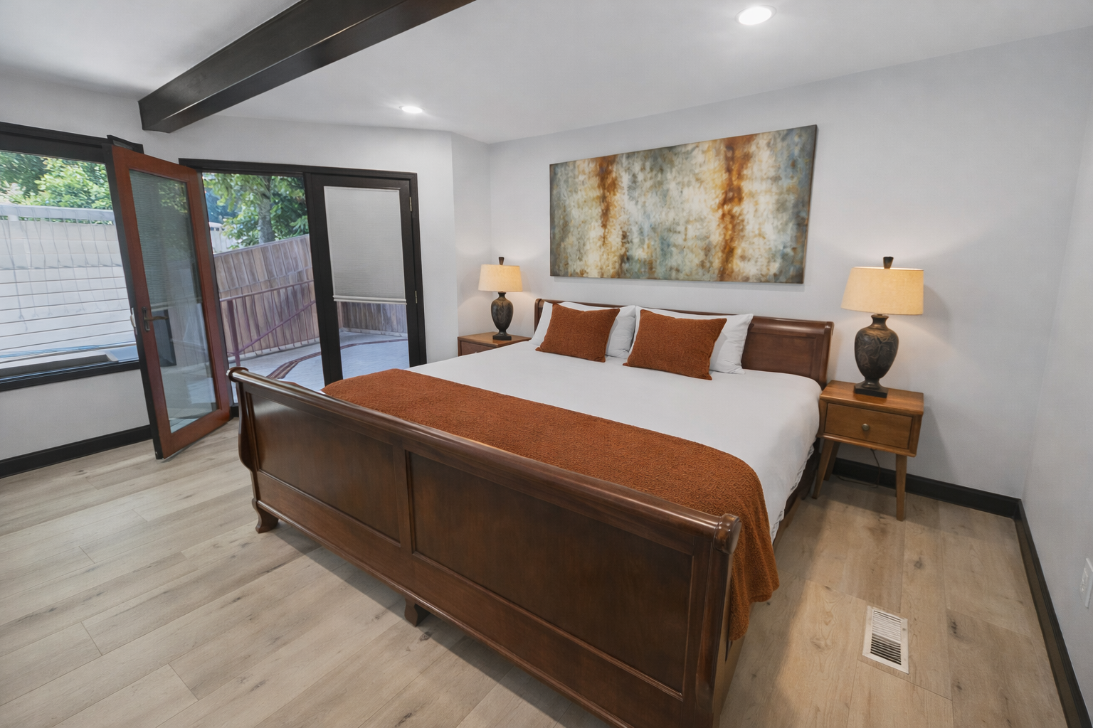 Rest peacefully in your elegant bedroom featuring a king bed, modern artwork, and private balcony access for morning coffee or evening relaxation.