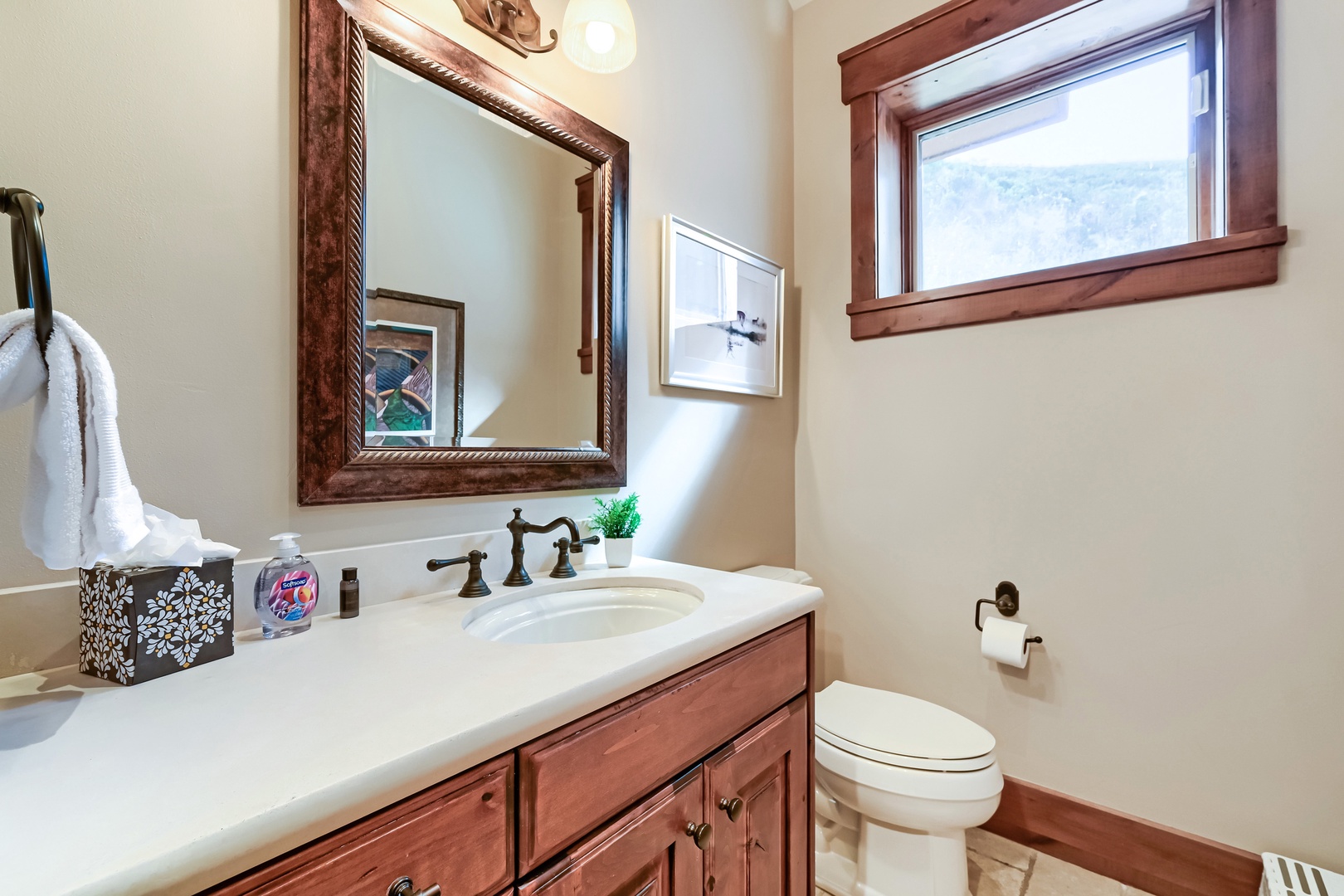 Step into your private powder room, where warm wood tones and soft natural light create a welcoming, refined space for freshening up during your stay.