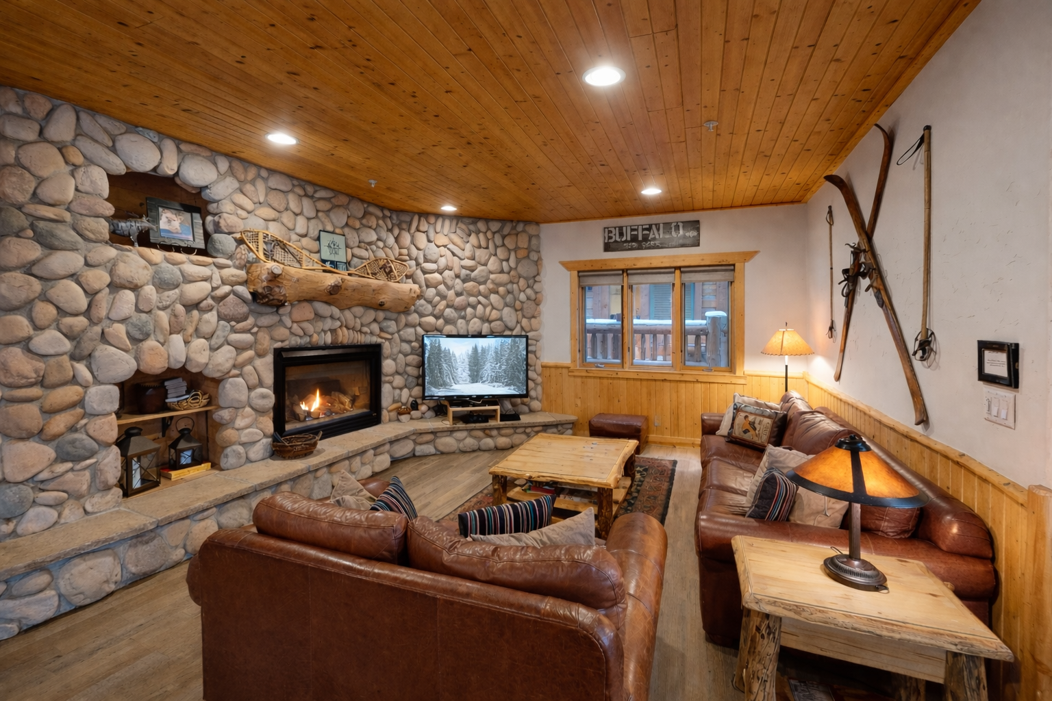 Cozy up by the crackling stone fireplace with your favorite show, surrounded by rustic charm and leather comfort.
