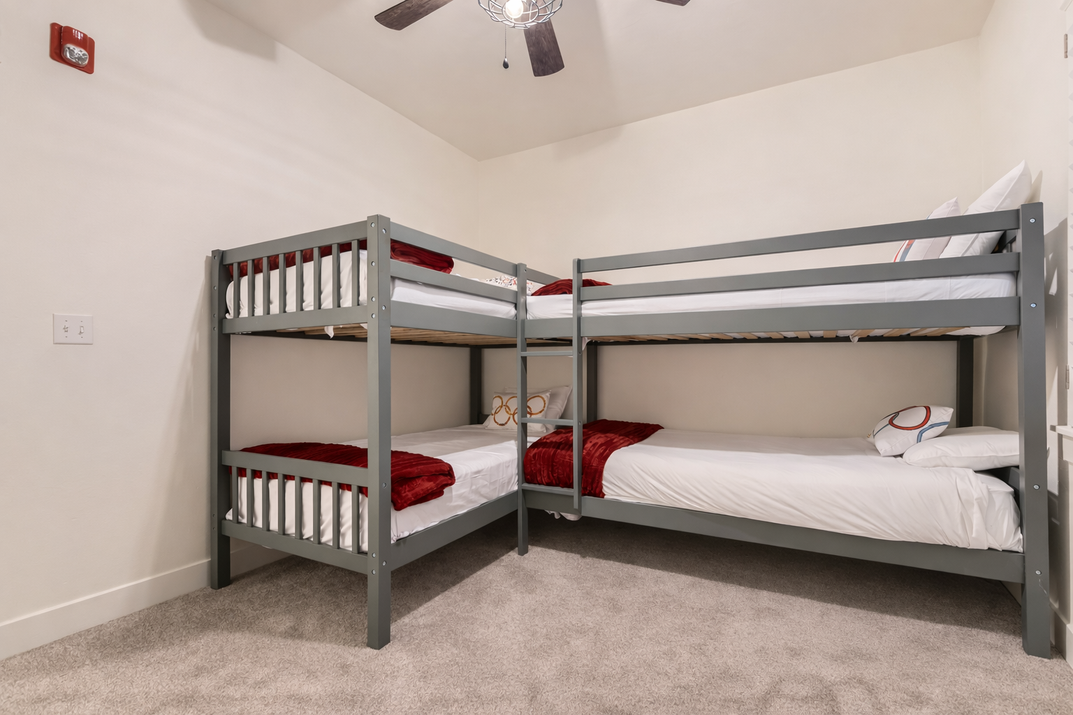 Your kids will love this cozy bunk room with fun decor, ceiling fan for comfort, and entertainment center for movie nights together.