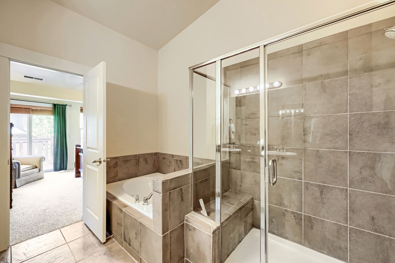 Step into your spa-like ensuite retreat with a luxurious soaking tub and spacious walk-in shower, both beautifully tiled for that resort feel.