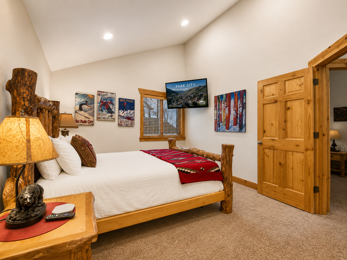 Settle into your cozy mountain-themed bedroom with handcrafted log furniture, crisp white linens, and ski-inspired artwork that captures the spirit of Park City's alpine charm.
