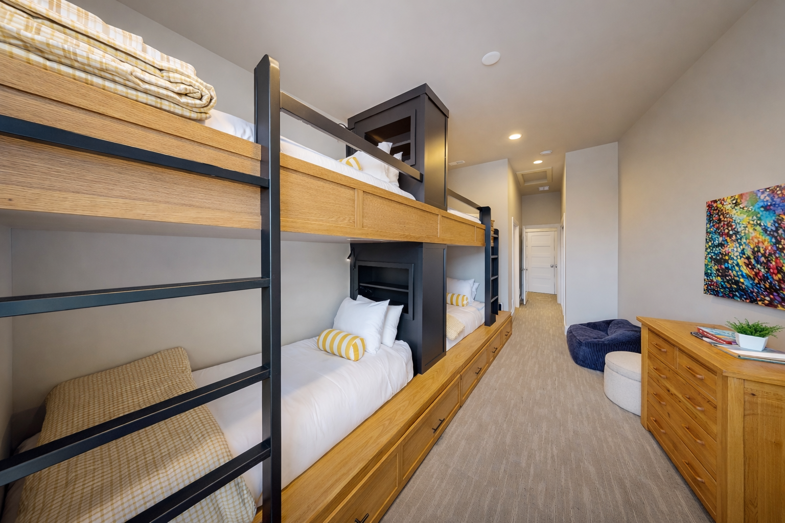 Sleep soundly in your thoughtfully designed bunk room featuring custom wood furnishings, crisp linens, and a cozy seating area for relaxation.