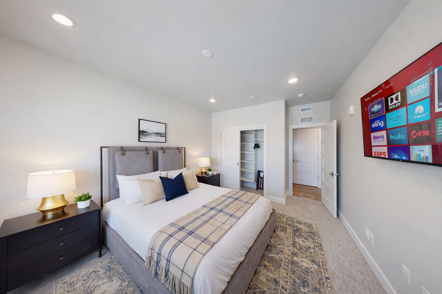Relax in this serene, contemporary guest suite featuring a plush king-sized bed and a sophisticated upholstered headboard. With soft, neutral tones and a tranquil atmosphere, this room serves as a peaceful sanctuary for rest and recharge.