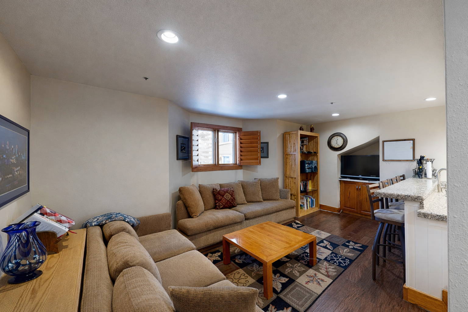Enjoy the cozy living room's plush sectional and rustic wooden coffee table, perfect for relaxing after a day of exploring Park City.