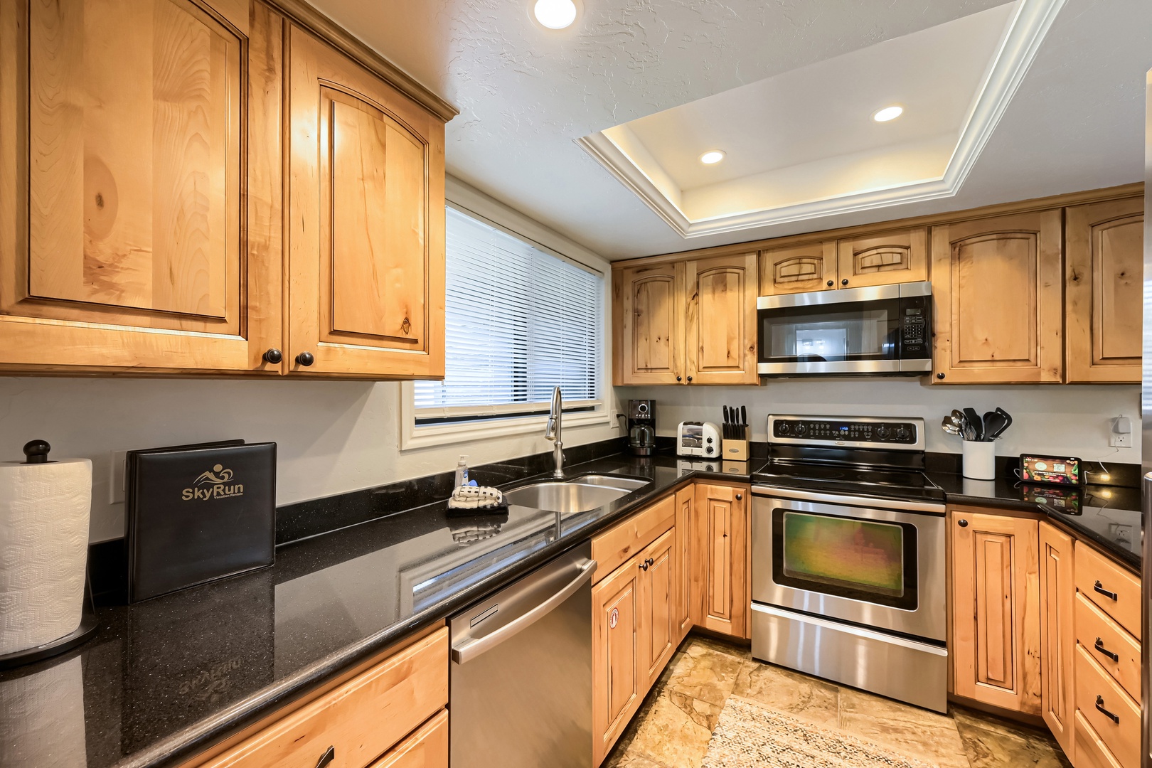 Your fully equipped kitchen features sleek granite countertops, stainless steel appliances, and beautiful natural wood cabinetry. Everything you need to prepare your favorite meals in comfort.
