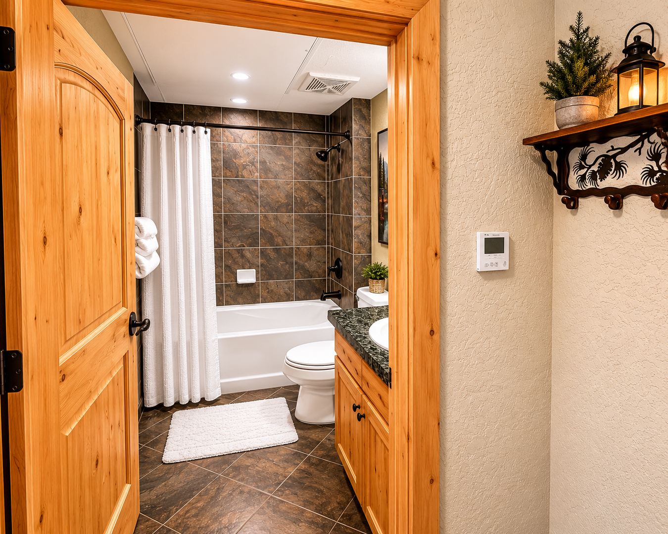This well-appointed bathroom features a classic bathtub with dark slate tile, a natural wood vanity, and a large mirror. Modern fixtures and bright lighting ensure a comfortable, refreshing start.