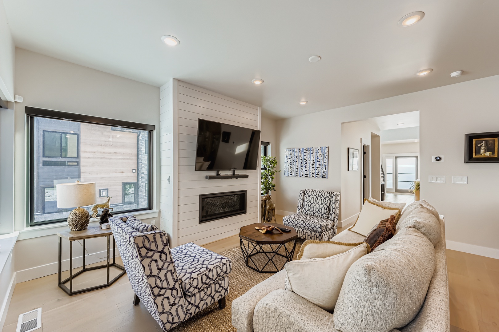 Settle into this inviting living room with plush seating, a cozy fireplace, and modern comforts—your perfect retreat after a day of adventure.